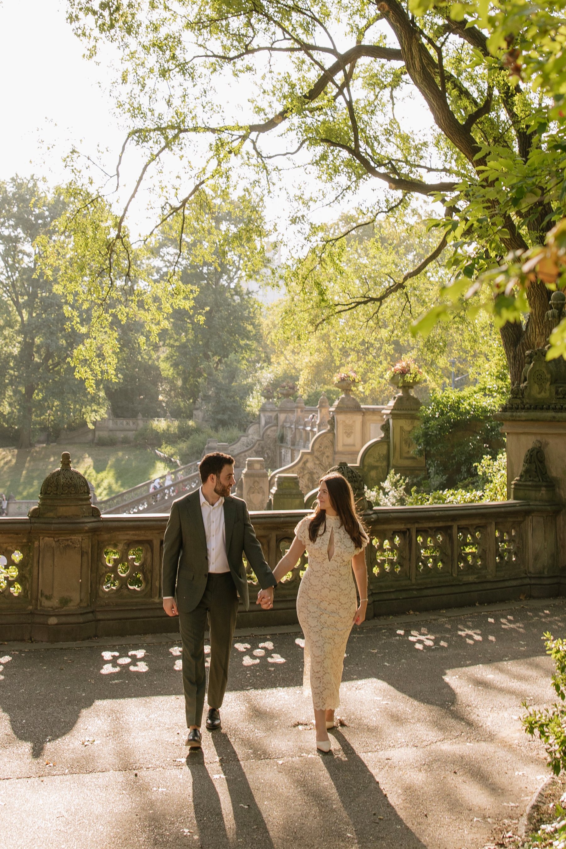 Sydney and Joseph walking hand in hand at Bethesda Terrace